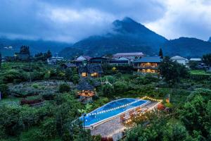 a resort with a swimming pool and a mountain at Stone Garden Resort & Spa in Sa Pa