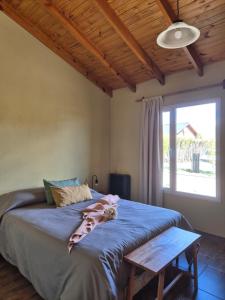 a bedroom with a bed with a dog laying on it at Casa Vind in El Calafate