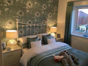 a bedroom with a bed and a window at Premier stays in Warrington