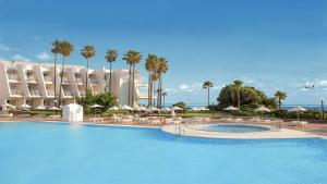 a large swimming pool in the middle of a city at Iberostar Royal Andalus in Chiclana de la Frontera