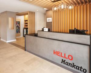 a hotel lobby with a hello marmite counter at TownePlace Suites by Marriott Mankato in Mankato +34 photos
