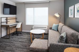 a living room with a couch and a desk at TownePlace Suites by Marriott Mankato in Mankato
