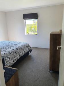 a bedroom with a bed and a window at Kauri Point Self Contained Unit in Tahawai