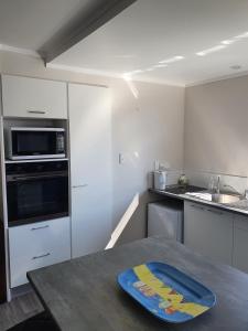a kitchen with a table with a tray on it at Kauri Point Self Contained Unit in Tahawai