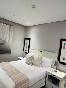 a bedroom with two beds and two night stands at Pearlview in Durban +51 photos