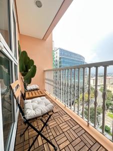 马尼拉Exquisite Japandi 2 & Mediterranean Breeze at Venice w Grand Canal View!的设有一个配有吊床的阳台,享有美景。