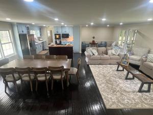 a living room with a dining table and a kitchen at Experience Serenity with Family and Friends in Macon