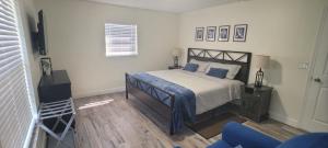 a bedroom with a bed and a blue chair at Lovely House in Sarasota close to UTC Mall Nathan Benderson Park and Siesta Key Beach in Sarasota