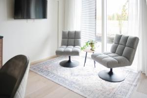 two chairs and a rug in a living room at Vario Hotel in Kokkola