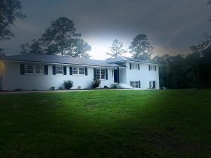 a white house with a green lawn in front of it at Experience Serenity with Family and Friends in Macon +7 photos