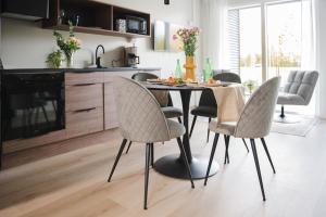 a kitchen and dining room with a table and chairs at Vario Hotel in Kokkola