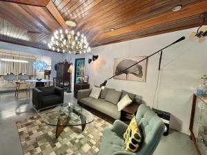 a living room with a couch and a table at Chic Designer Room in Shared Bungalow SS1 Near LRT Petaling Jaya in Sungai Way