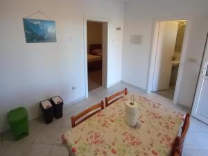 a dining room with a table with a candle on it at Comfort One Bedroom Apartment with Terrace and Sea view in Sveta Nedelja