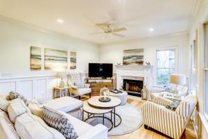 a living room with white furniture and a fireplace at OG14: 14 Ocean Green in Kiawah Island