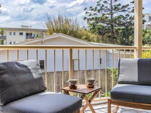 a balcony with two chairs and a table at Wave Whisperer in Kingscliff