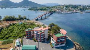an aerial view of a city and a bridge over a body of water at tongyeong haegando pension in Tongyeong