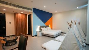 a room with a couch and a bed and a table at Hollandse Club Retreat in Singapore +19 photos