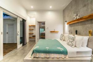 a bedroom with a large bed with a green blanket at Deimena Cozy 3 BR Private Pool Villa ZN353 in Pererenan +25 photos