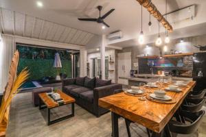 a living room with a table and a couch at Deimena Cozy 3 BR Private Pool Villa ZN353 in Pererenan