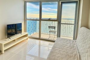a living room with a bed and a large window at Modern Seaview 1BR Near Okada Manila Bay Airport 17 in Manila