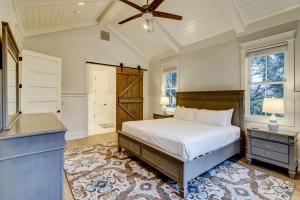 a bedroom with a bed and a ceiling fan at AV3-23: 3 23rd Avenue in Isle of Palms +68 photos