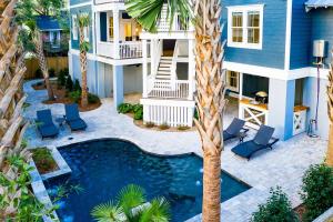 a house with a swimming pool and a palm tree at AV3-23: 3 23rd Avenue in Isle of Palms