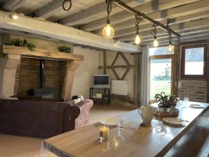 a living room with a couch and a table at Gîte chaleureux à Chapeau avec jardin et terrasse - FR-1-489-601 in Chapeau
