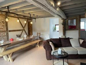 a living room with a couch and a table at Gîte chaleureux à Chapeau avec jardin et terrasse - FR-1-489-601 in Chapeau