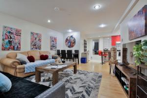 a living room with a couch and a table at FREE PARKING - 5 minute walk to METRO STATION "Berri Uqam" - In-Suite WASHER & DRYER - fully stocked KITCHEN - WORKSPACE PROVIDED - FAST WIFI in Montréal +131 photos