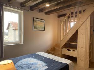 a bedroom with a bunk bed and a wooden staircase at Gîte chaleureux à Chapeau avec jardin et terrasse - FR-1-489-601 in Chapeau