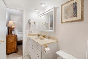a white bathroom with a sink and a mirror at PW13103: 13103 Pelican Watch in Seabrook Island +50 photos