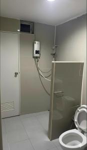a bathroom with a toilet and a shower stall at Phimpakan guesthouse in Nakhon Phanom