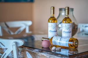 two bottles of wine sitting on top of a table at JuliaStudios in Amoudi