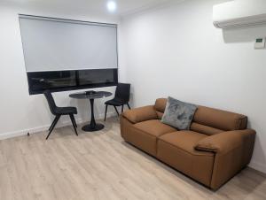 a living room with a couch and a table at Munibung Apartments in Cardiff