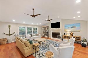 a living room with white furniture and a flat screen tv at AV3-20: 3 20th Avenue in Isle of Palms