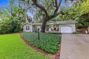 a white house with a tree and a driveway at AV3-20: 3 20th Avenue in Isle of Palms