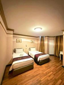 Postel nebo postele na pokoji v ubytování Hotel De Khuvieng