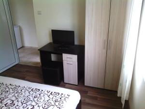 a room with a desk with a television and a bed at Bungalows St. Nicola in Ahtopol +21 photos