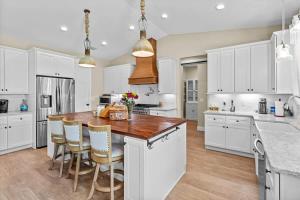 a kitchen with white cabinets and a wooden counter top at Charming 3BR Waterfront Home - Private - Serene in Inverness