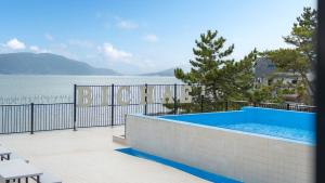a swimming pool with a view of the water at Sacheon Bichae Pension in Sacheon