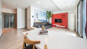 a living room with a table and a couch at Sacheon Bichae Pension in Sacheon