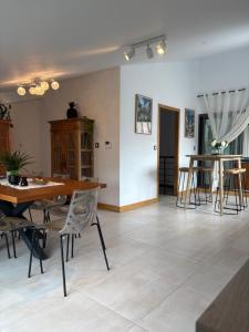 a living room with a dining room table and chairs at Chambre Saint Gilles les bains1 in Saint-Paul