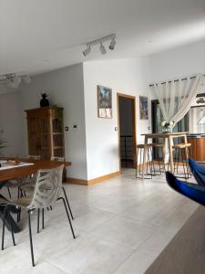 a living room with a table and chairs at Chambre Saint Gilles les bains1 in Saint-Paul +3 photos