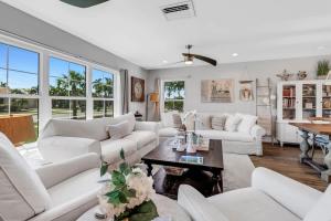 a living room with white couches and a table at Inviting Lakeview Home l Pool l Close to Beaches in Marco Island