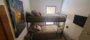 a small room with two bunk beds in it at Downtown Dog Friendly House in Fargo