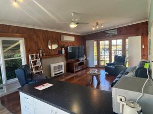 a living room with a couch and a tv at Port Sorell Beach Shack in Port Sorell