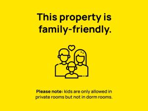 a yellow sign that says this property is family friendly at The Hosteller Narkanda in Nārkanda