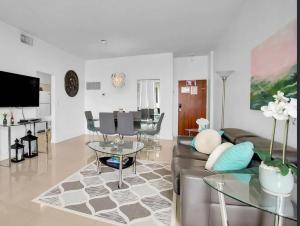a living room with a couch and a table at Oceanfront Penthouse with Intercoastal Views in Hollywood Beach
