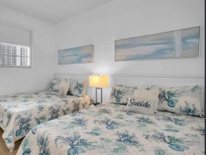 a bedroom with two beds and a lamp in it at Oceanfront Penthouse with Intercoastal Views in Hollywood Beach