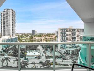 a balcony with a view of a city with palm trees at Oceanfront Penthouse with Intercoastal Views in Hollywood Beach